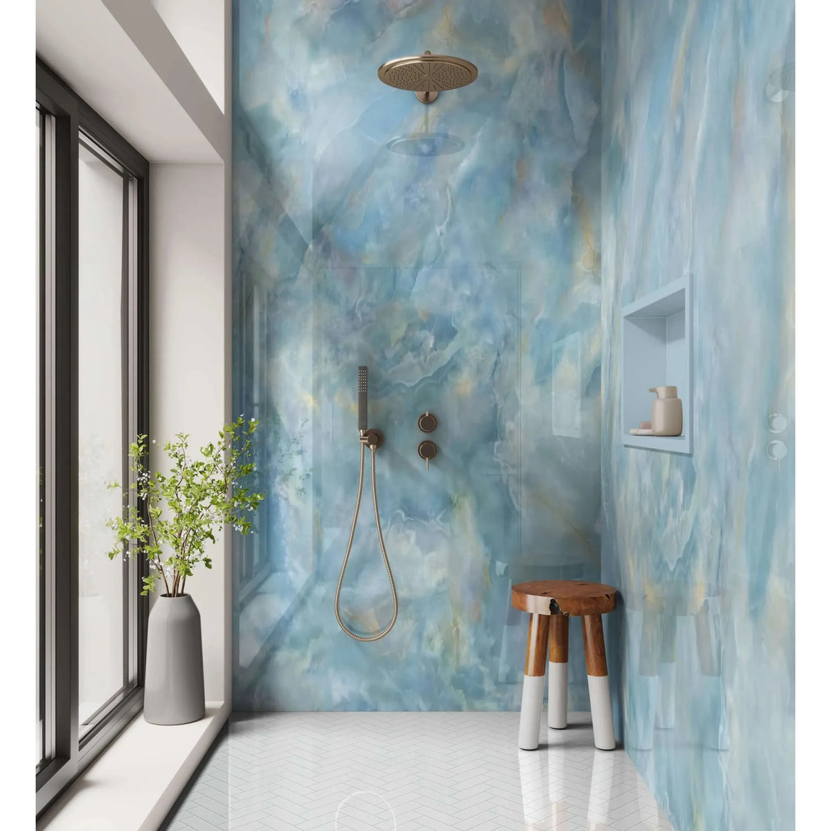Gold-toned circular showerhead with sleek modern design mounted on blue marble wall in shower panel onyx crystal carte d’or blue