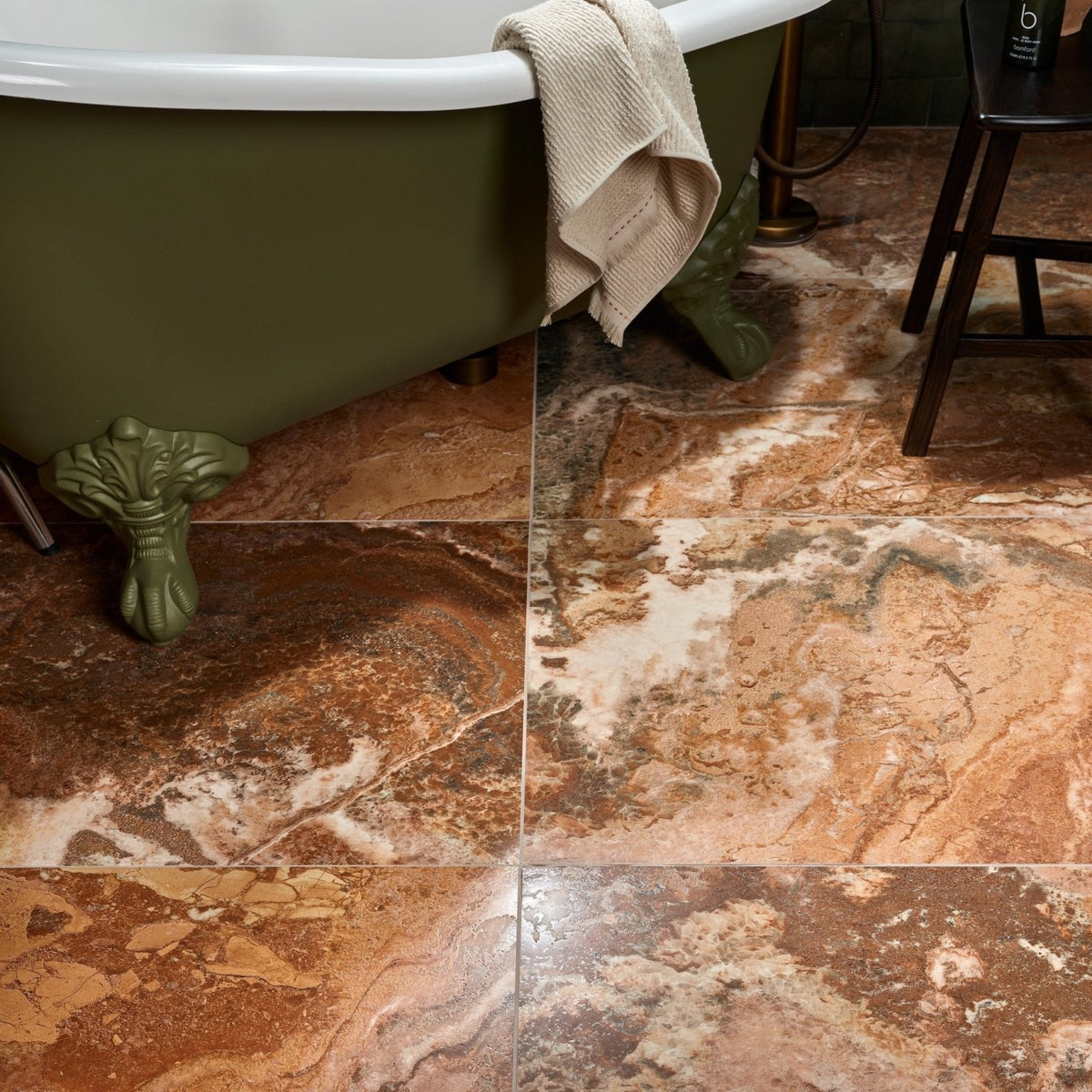 Sicilia Porcelain Brushed brown and gold marble-effect tiles with an olive-green clawfoot bathtub