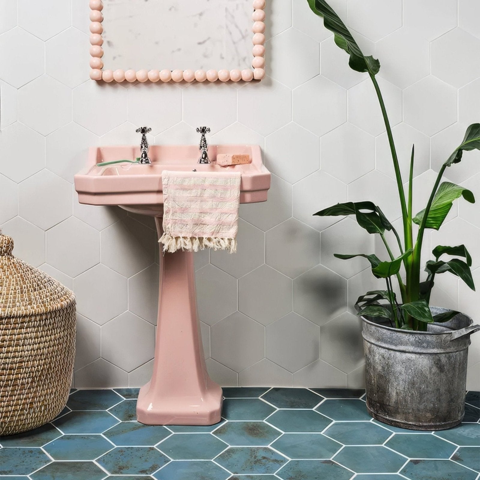 Pink ceramic pedestal sink with chrome faucets from the signature porcelain verdigris collection
