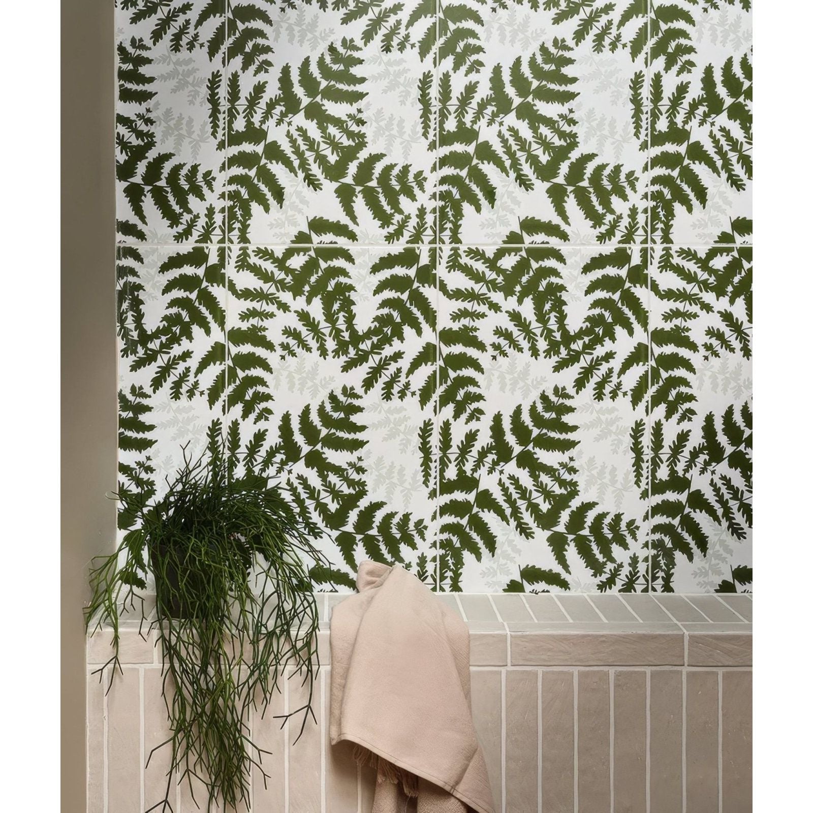 White ceramic tiles with a repeating pattern of dark green fern leaves from silk screen ceramic fernery collection