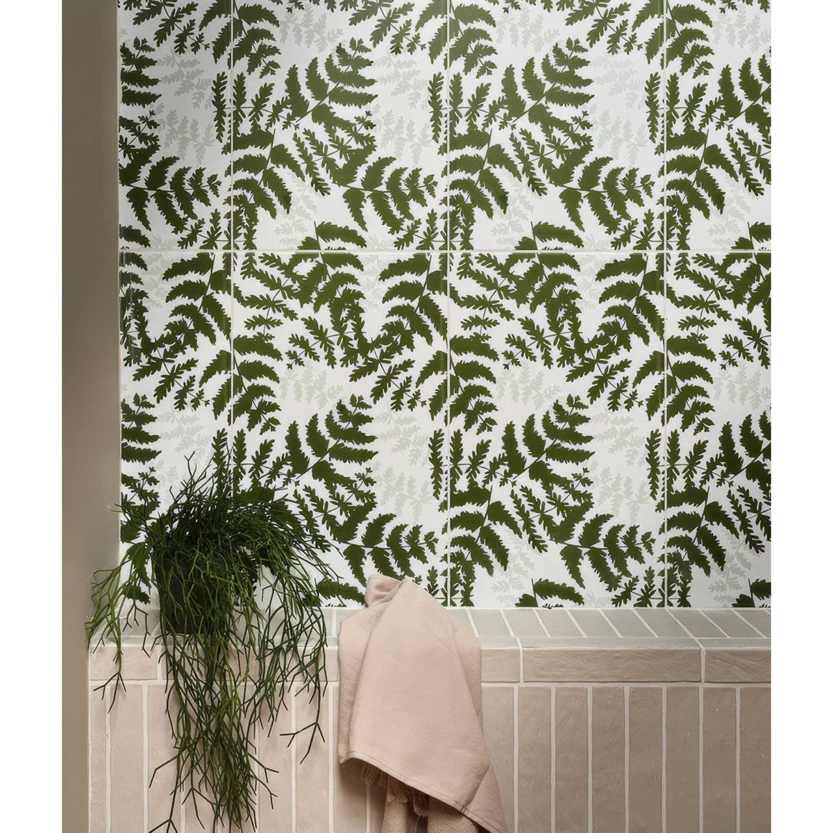 White ceramic tiles with a repeating pattern of dark green fern leaves from silk screen ceramic fernery collection