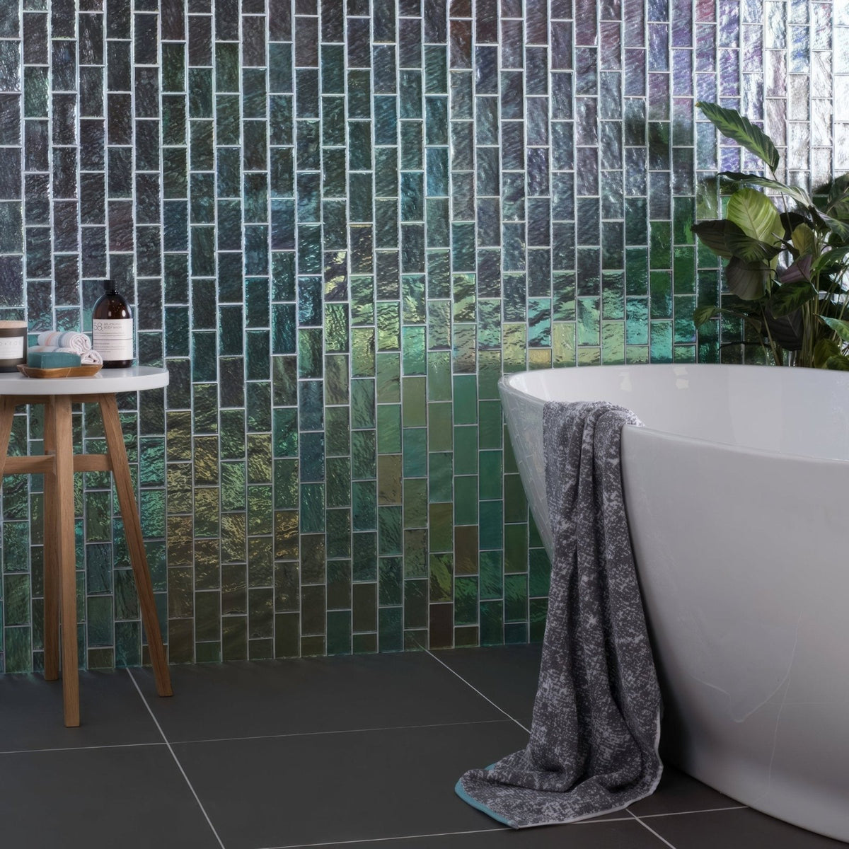 Silver gloss mosaic radiance iridescent green and blue glass rectangular tiles forming a shimmering textured wall
