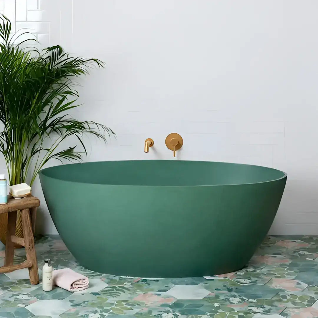 A sleek, matte-finish emerald green freestanding bathtub with minimalist gold-toned fixtures.