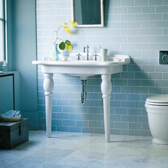 White ceramic pedestal sink smoke blue with ornate turned legs and vintage-inspired classic design