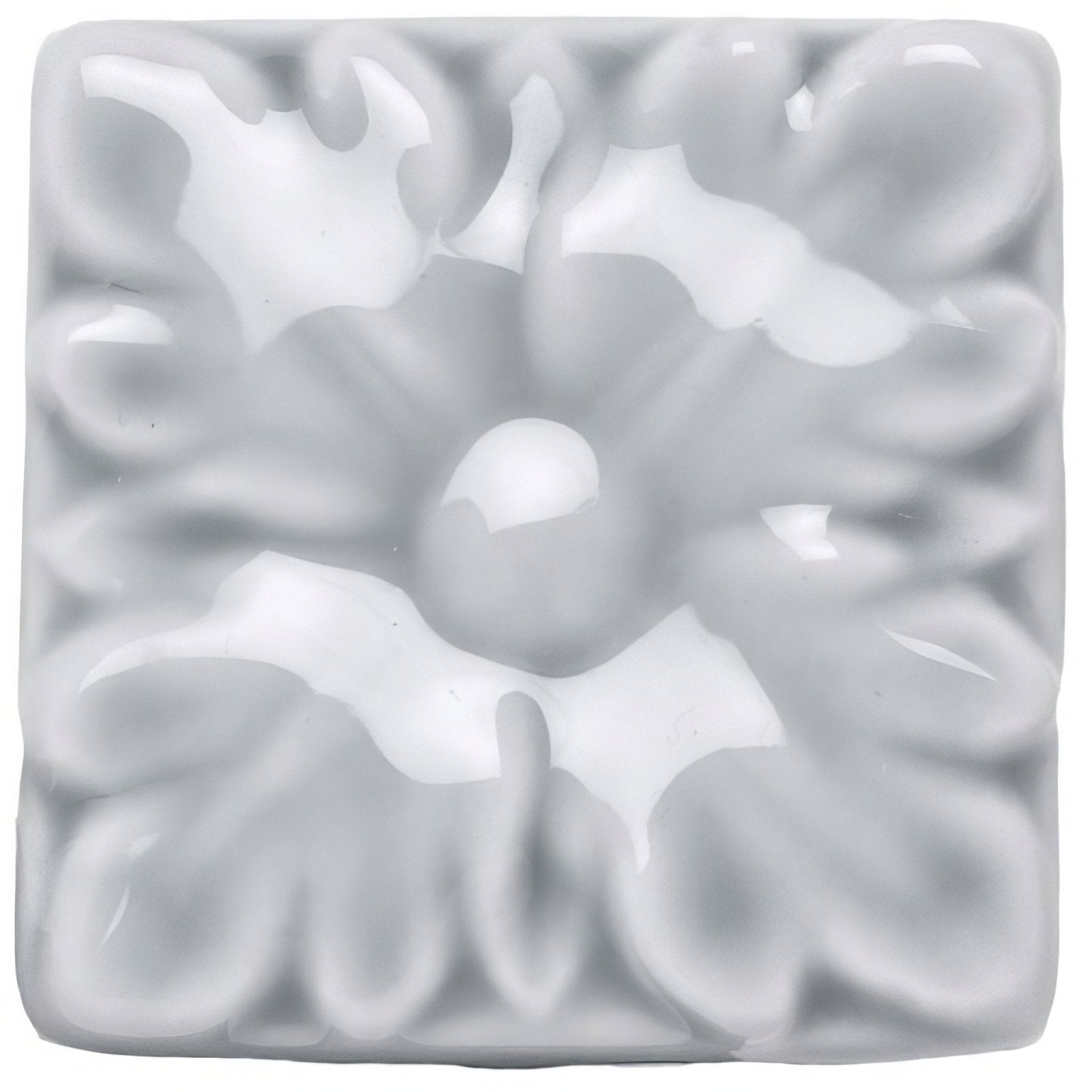 A square glossy white ceramic tile with a raised floral design from snape knightsbridge collection