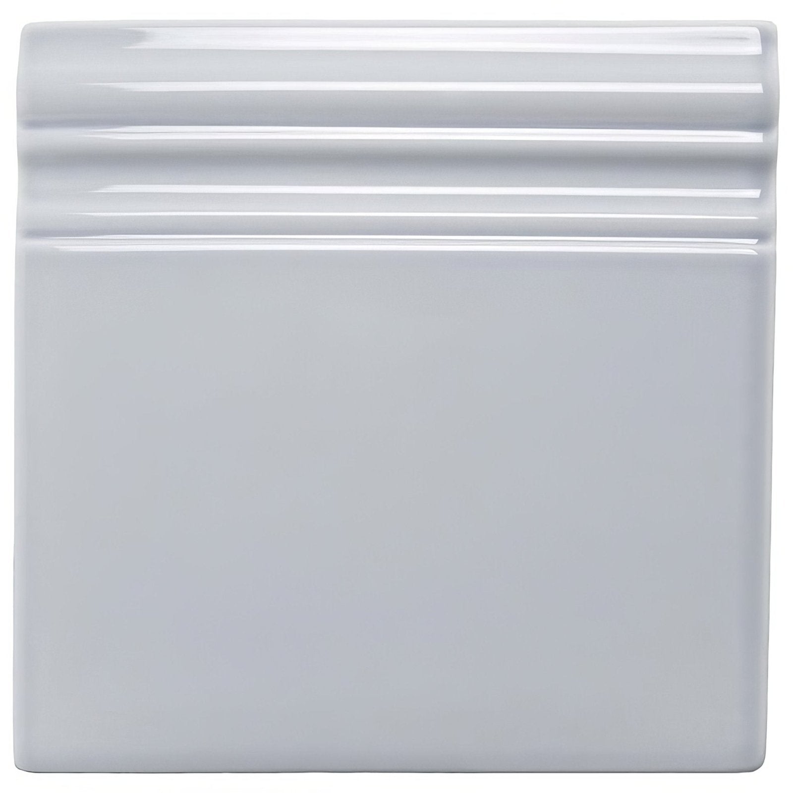 White ceramic snape skirting tile with glossy finish and decorative ridged border for wall accents