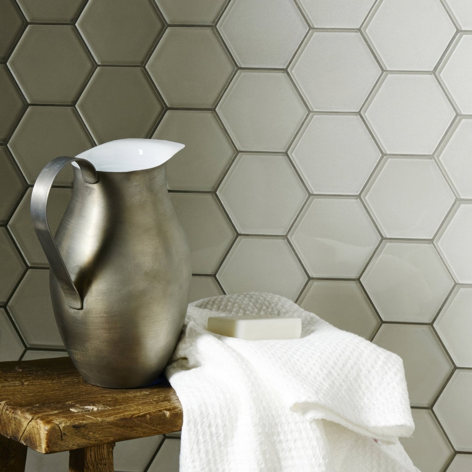 Solinda Metallic Hexagon Mosaics silver hexagonal glass mosaic with a metal pitcher on a stool