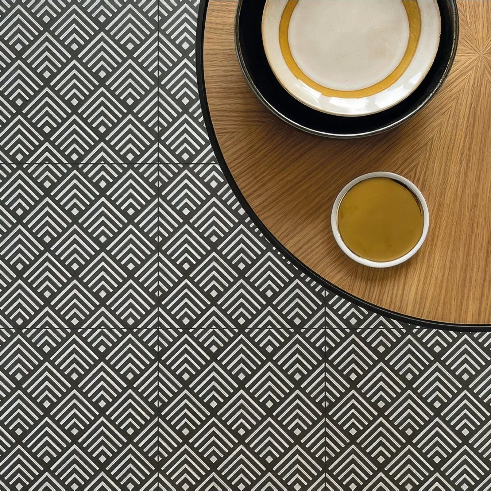 Black and white geometric patterned floor tiles with a repeating diamond design made of porcelain in the Sorrento Correale collection