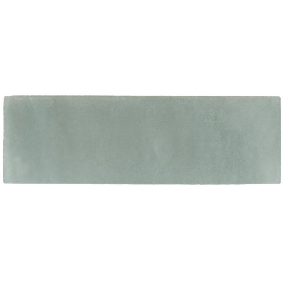 A rectangular matte ceramic tile in soft sage green from the south cliff mist brick tile collection