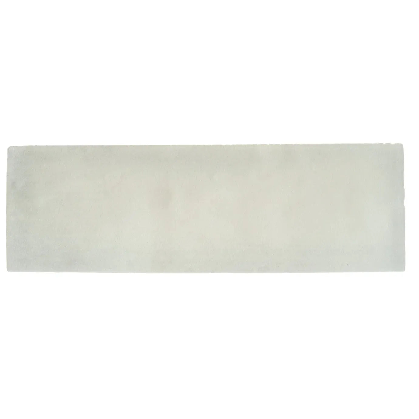 A rectangular off-white ceramic south cliff cotton brick tile with a smooth slightly textured surface and subtle tone variations