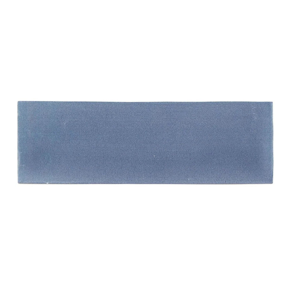 A rectangular matte-finished blue ceramic tile with a subtle textured surface from south cliff ocean brick tile