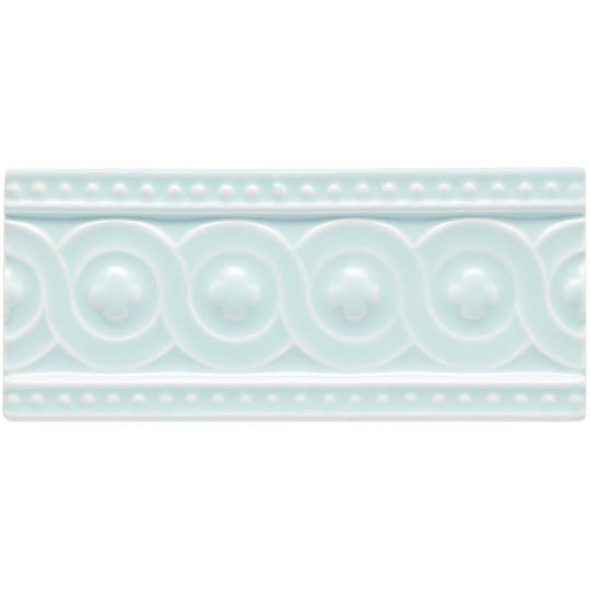 A rectangular light mint-green ceramic tile southwold baroque with raised decorative border and circular motifs