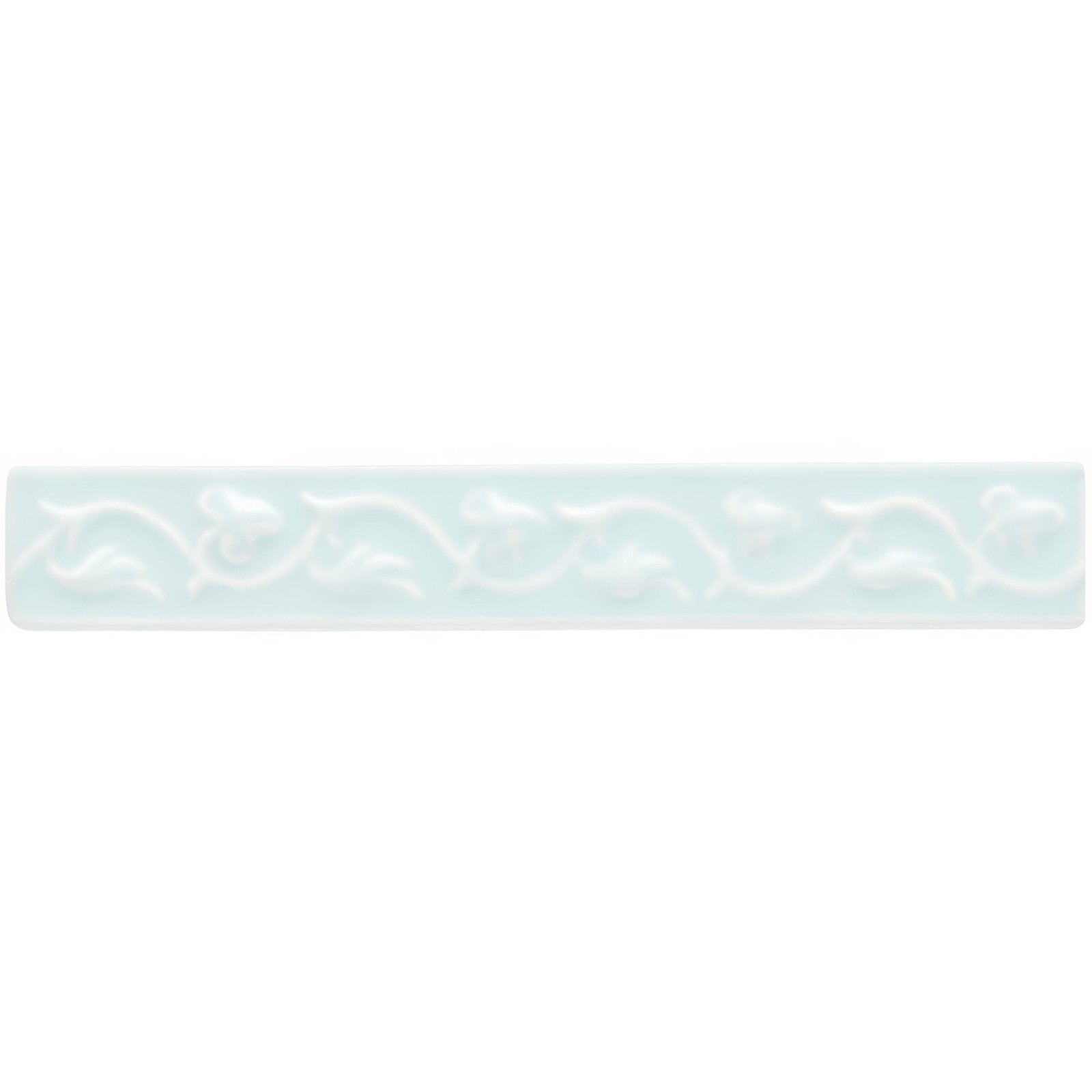 A rectangular light blue ceramic tile with a subtle embossed floral pattern from southwold beaulieu collection