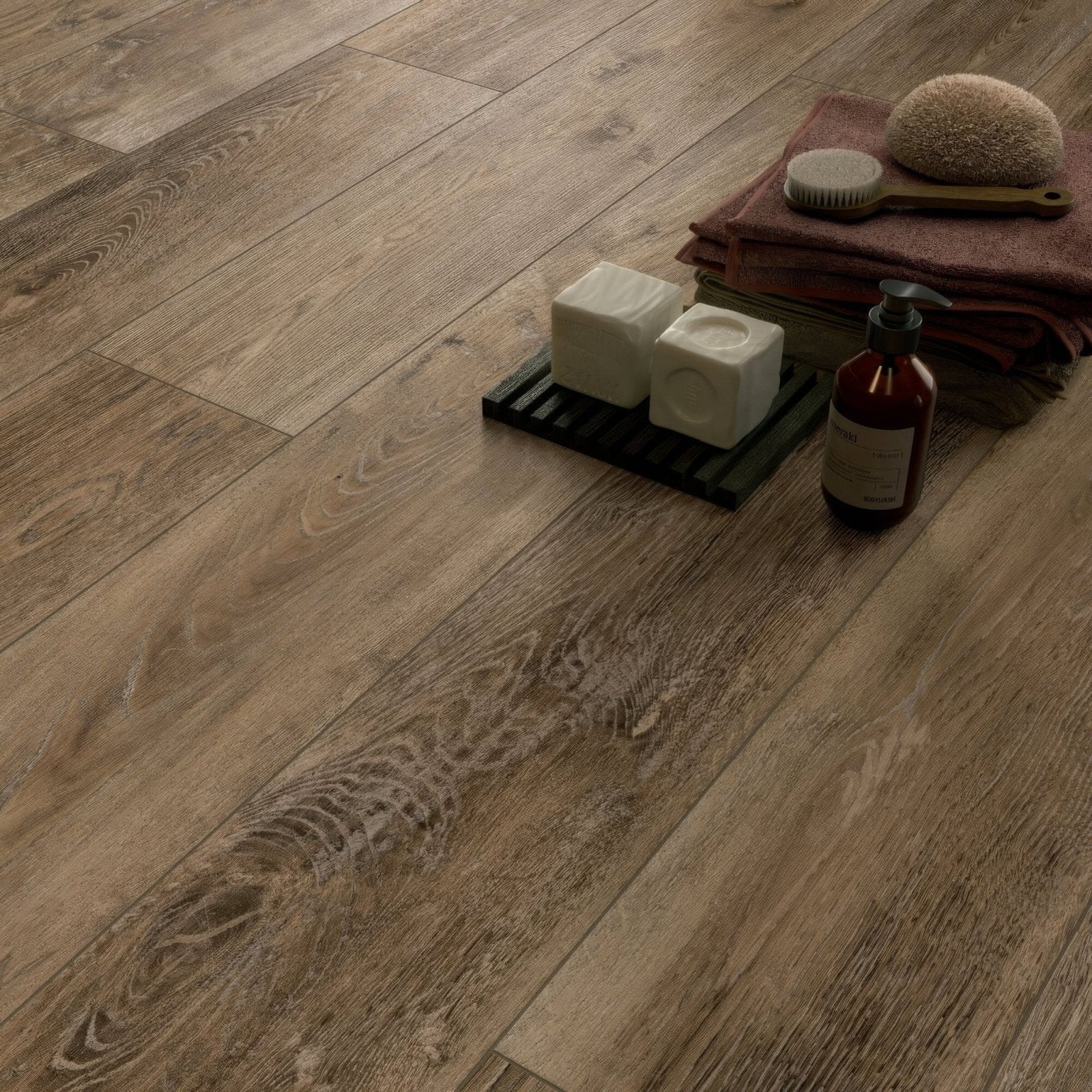 Brown wood-effect vinyl plank flooring with natural grain pattern in southwold elm herringbone design