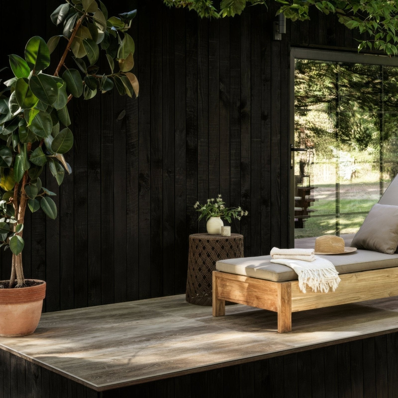 Light wood outdoor lounge chair with cushion and throw blanket from Southwold Sycamore Plank collection