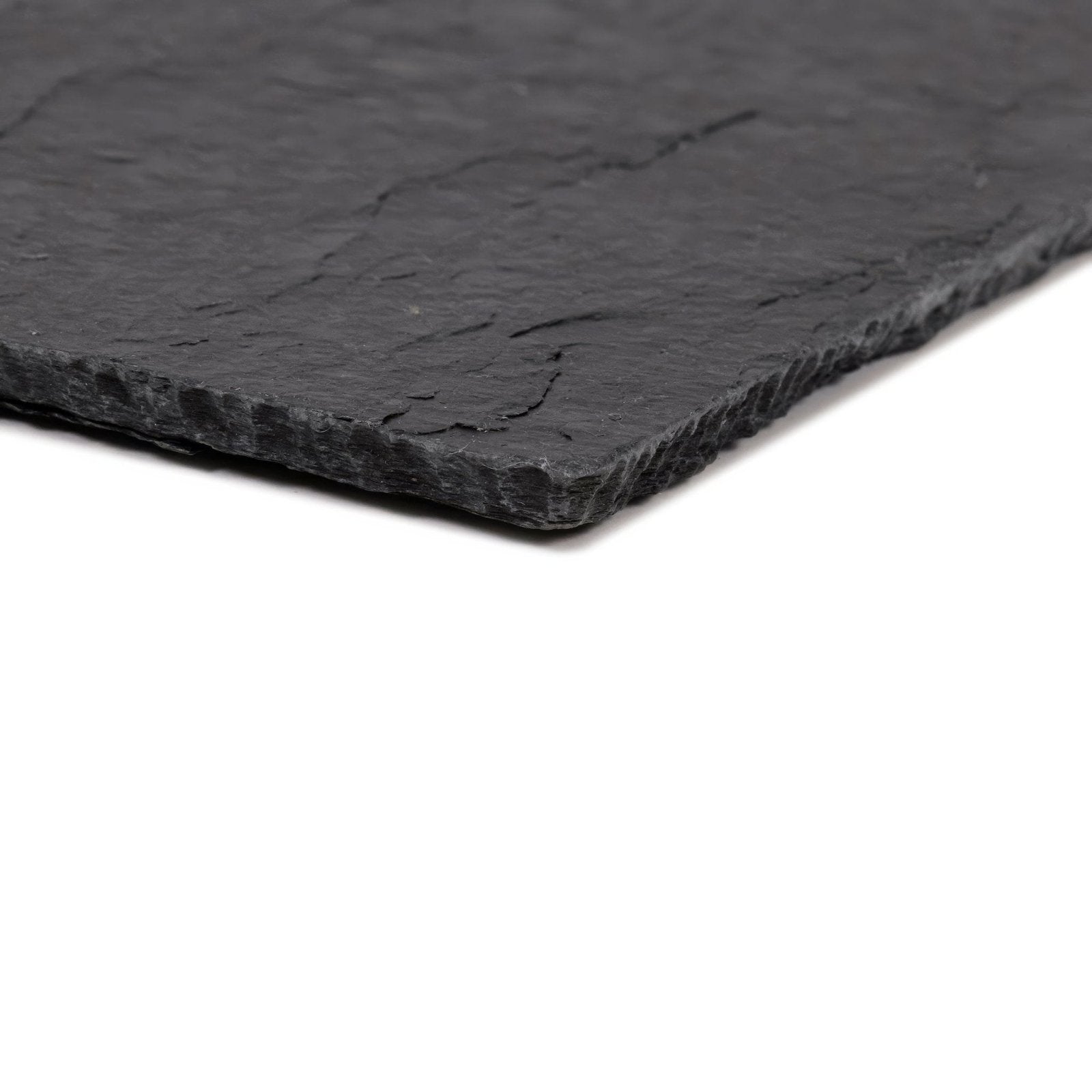 Black slate serving board with natural textured surface and irregular chipped edges spanish black 25 x 40 riven