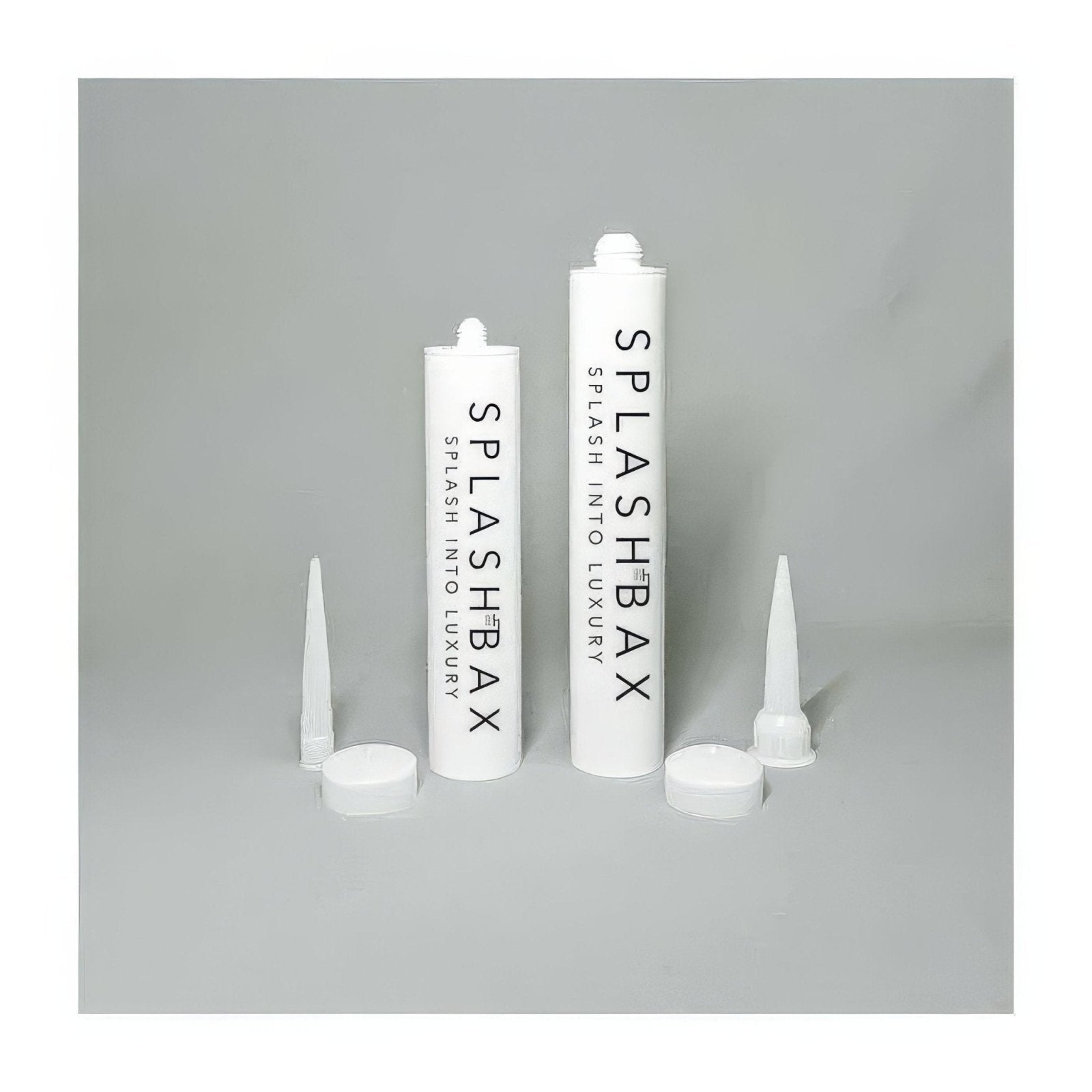 Two white plastic tubes of splashbax adhesive clear with matching caps and pointed nozzles for precise application
