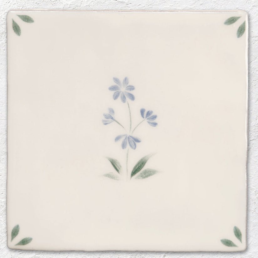 Cream-colored ceramic tile spring alice 13 x 13cm with delicate hand-painted floral design in blue and green hues