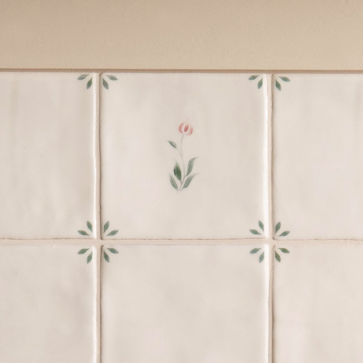 Off-white ceramic spring emma tile 13 x 13cm with delicate hand-painted pink and green floral motifs