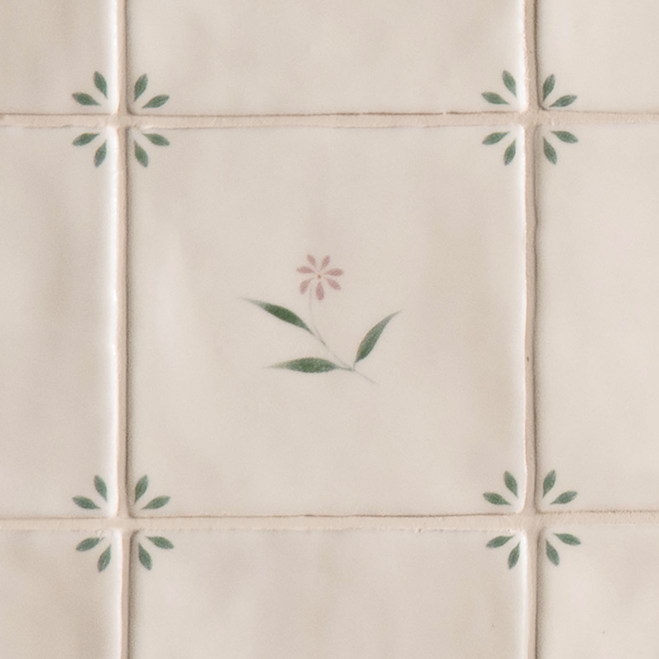 Cream-colored ceramic spring lucie 13 x 13cm tiles with delicate hand-painted soft pink and green floral motifs
