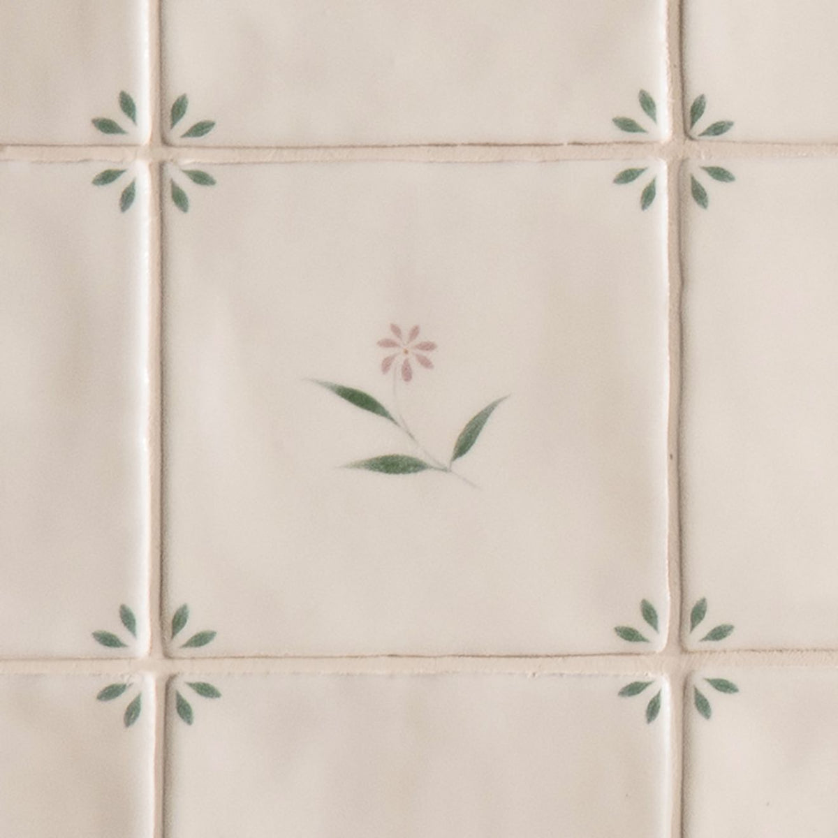 Cream-colored ceramic spring lucie 13 x 13cm tiles with delicate hand-painted soft pink and green floral motifs