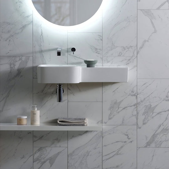Statuarietto Honed 60x30cm white marble-effect tiles with a wall-mounted sink and chrome tap