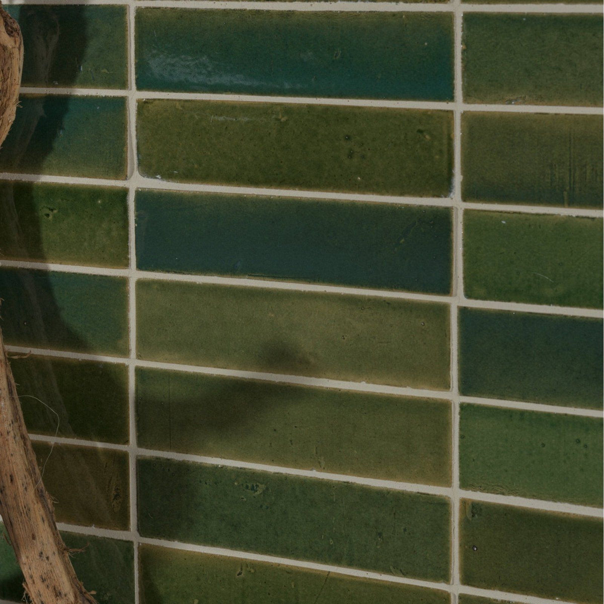 Stone glaze ceramic british green gloss brick tiles with glossy finish and subtle shade variations in a grid pattern