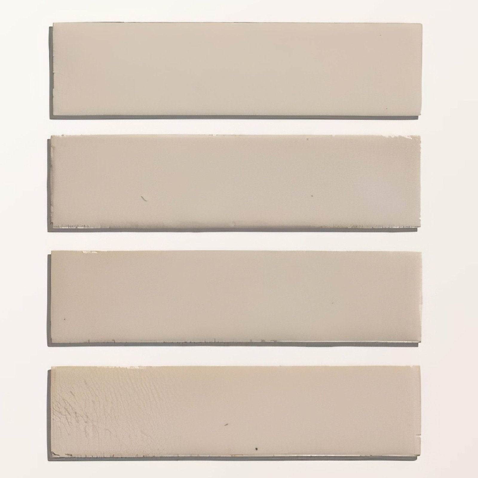 Four beige stone glaze ceramic chalkstone gloss brick tiles with smooth surface and subtle tone variations
