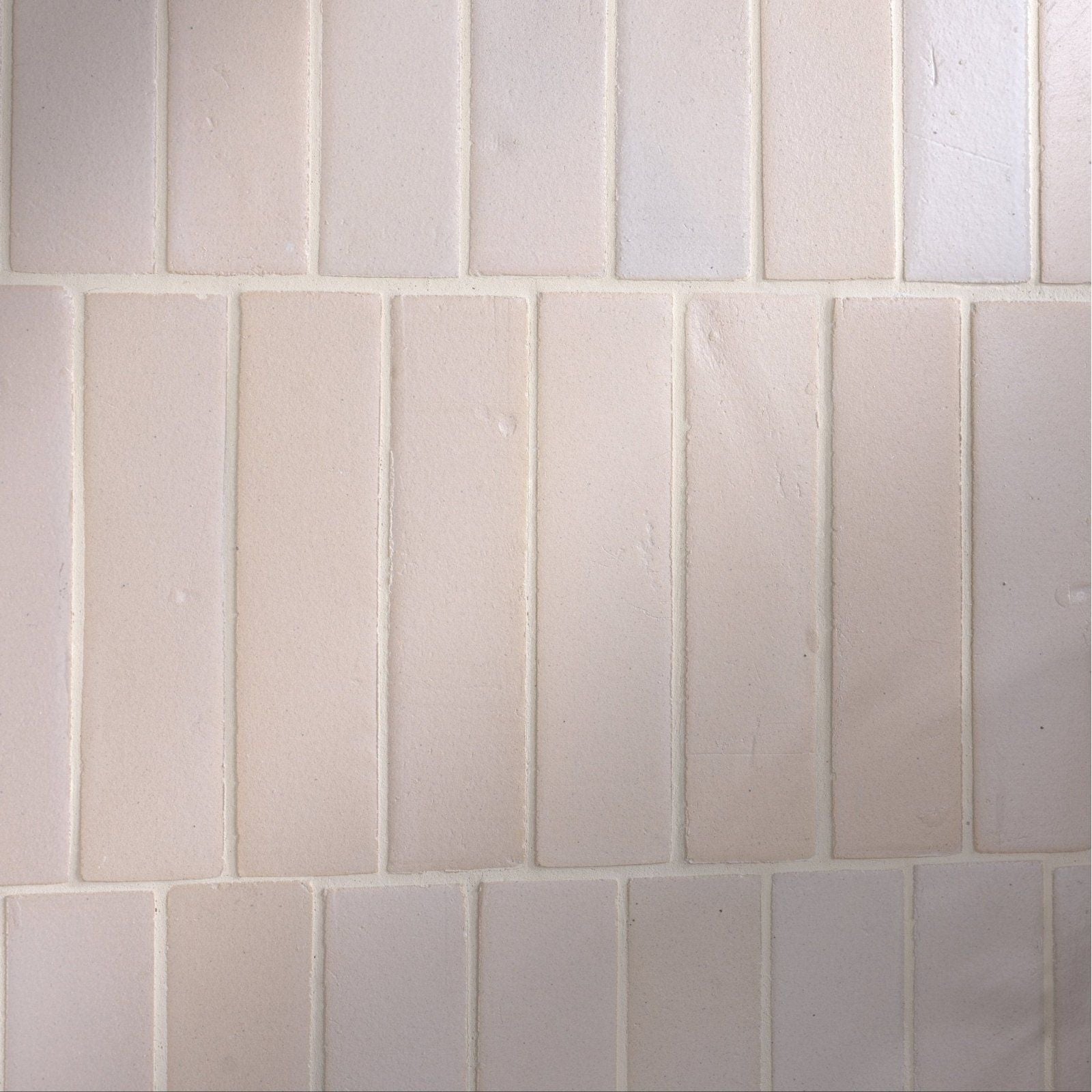 Off-white rectangular stone glaze ceramic chalkstone gloss brick tiles with subtle texture and uniform grout lines