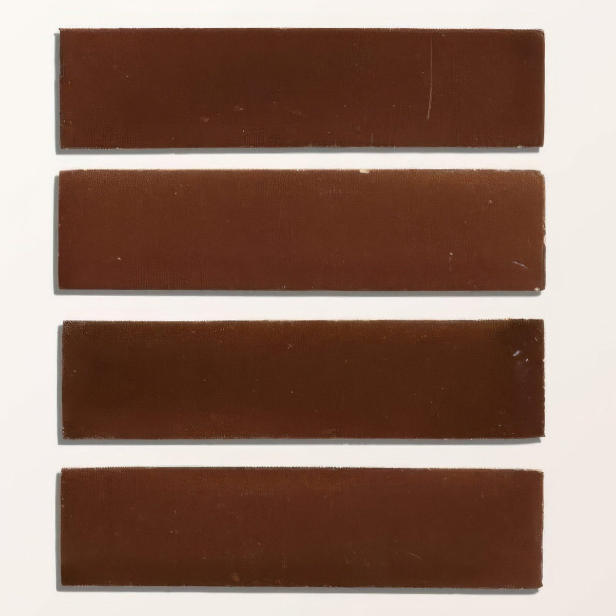 Four rectangular brown stone glaze ceramic cola gloss brick tiles arranged vertically for wall or floor use