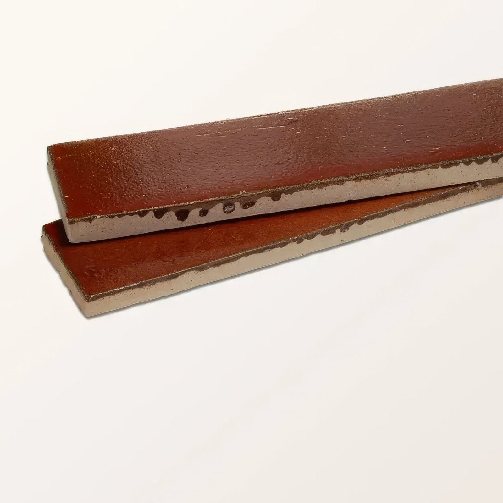 Two rectangular rustic brown ceramic tiles with textured glaze and visible edges from stone glaze ceramic imperial red gloss brick