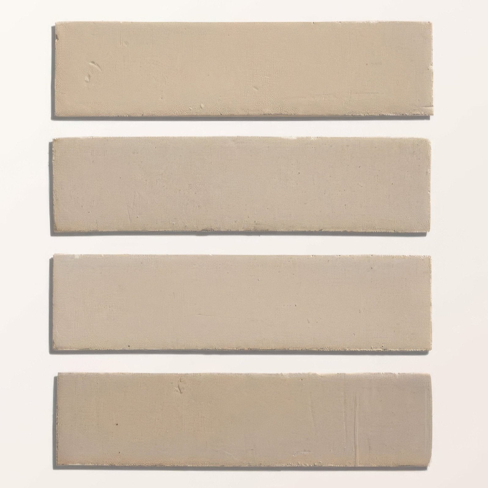 Four beige rectangular ceramic tiles with a linen gloss finish in stone glaze ceramic brick style arranged vertically