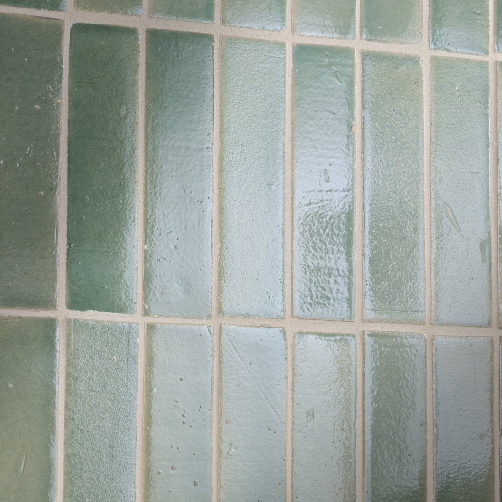 Green rectangular glass tiles with textured frosted finish arranged in grid pattern stone glaze ceramic menthol gloss brick