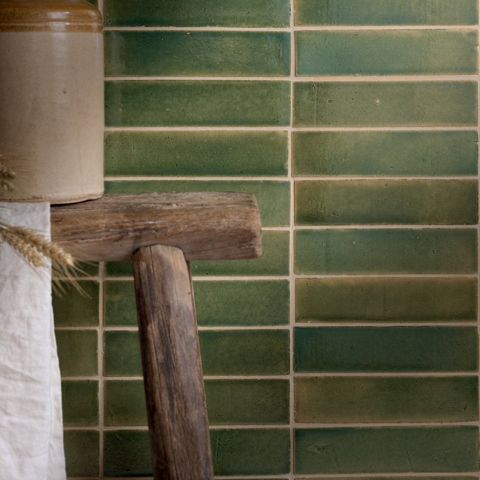 Green rectangular ceramic tiles with a rustic glazed finish arranged in horizontal rows stone glaze ceramic olive leaf gloss brick