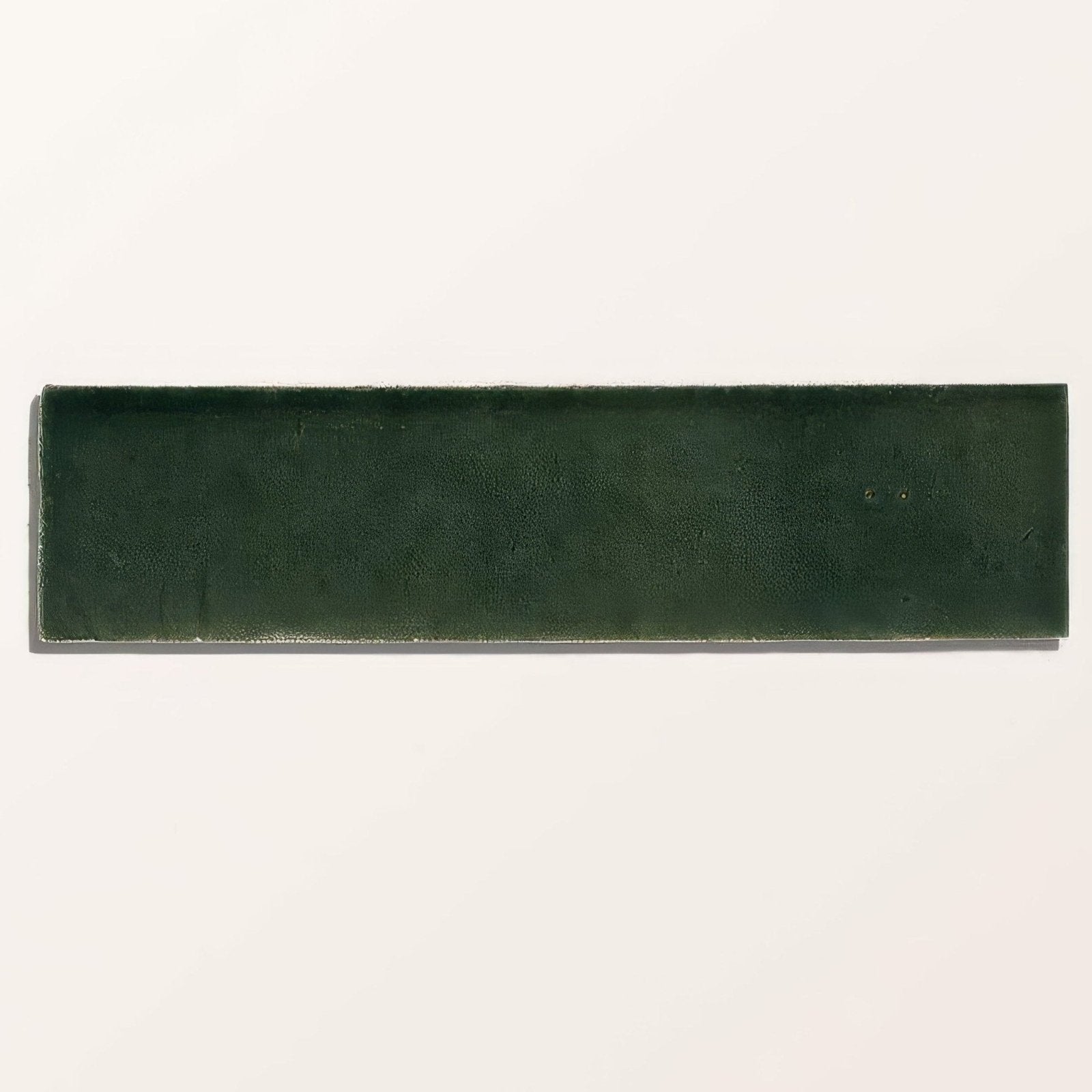 Dark green rectangular ceramic tile with a textured matte finish from stone glaze ceramic petrol green gloss brick collection