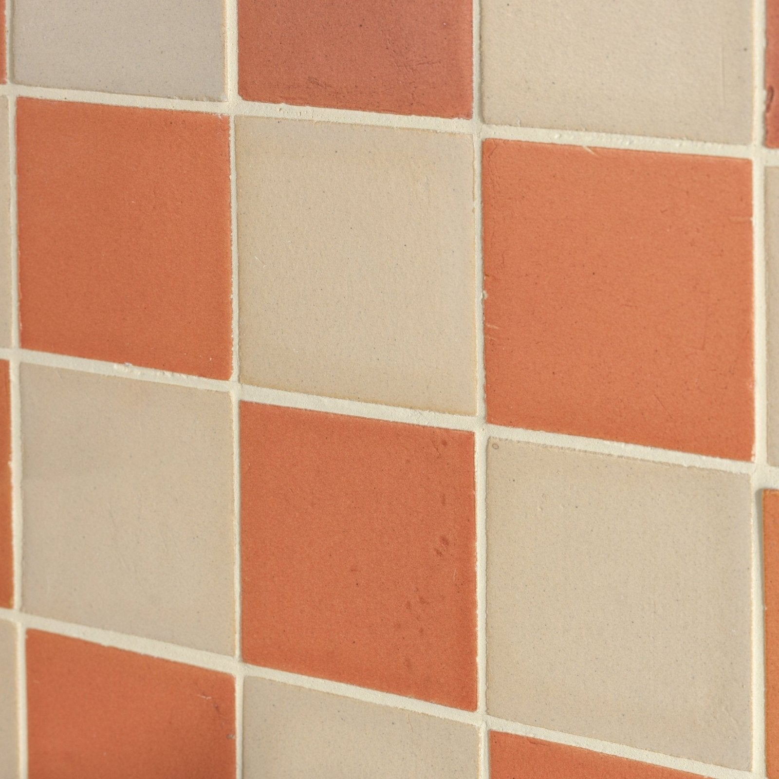 Stone glaze ceramic terra matt square tiles in terracotta and cream arranged in a checkerboard pattern