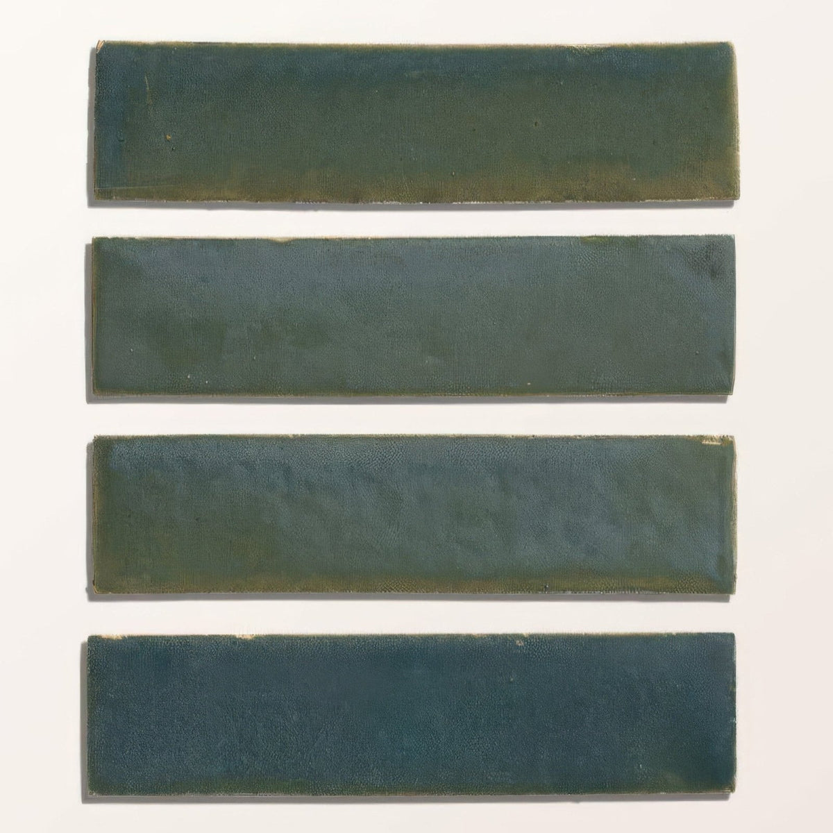 Four matte dark green ceramic tiles with subtle tone variations from stone glaze ceramic winter pond gloss brick