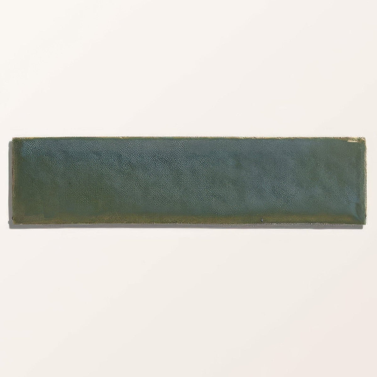 A rectangular ceramic brick tile with textured matte dark green stone glaze and subtle tone variations called winter pond gloss