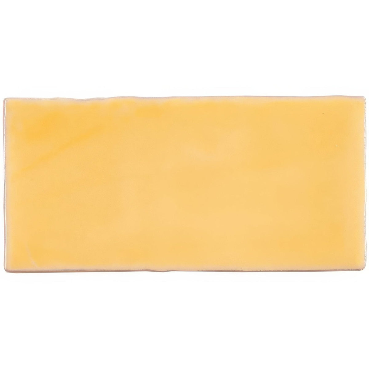 A rectangular solid yellow ceramic straw half tile wall tile with a smooth slightly glossy finish