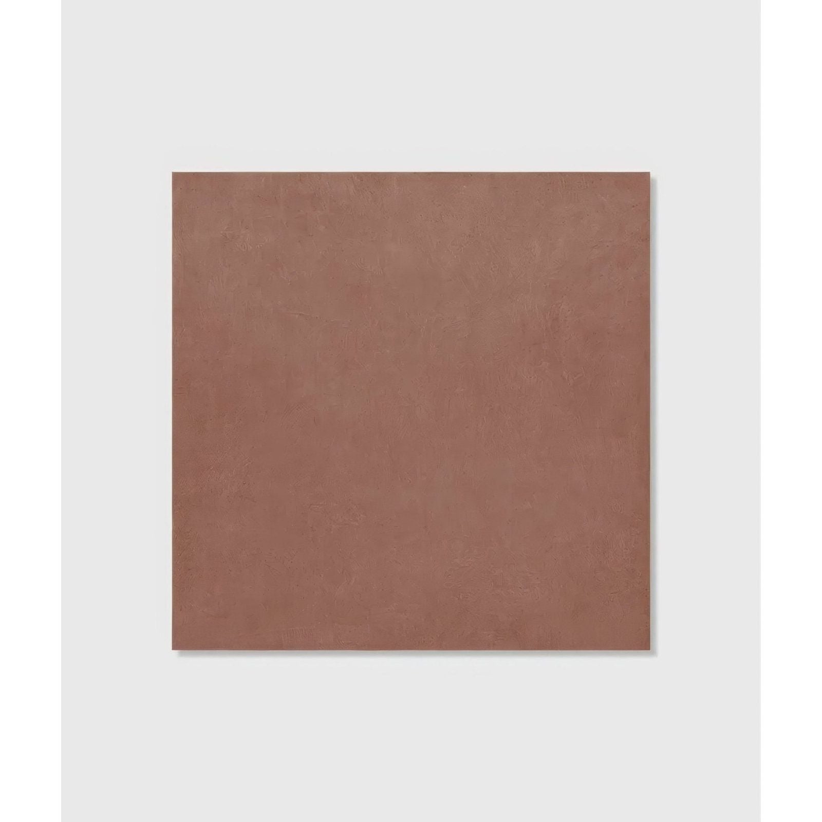 A square matte finished terracotta colored stucco porcelain tile with a subtle textured surface