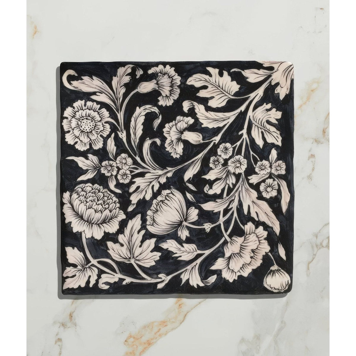 Black ceramic tile studio assisi blue featuring intricate white vintage hand-painted floral and leaf patterns