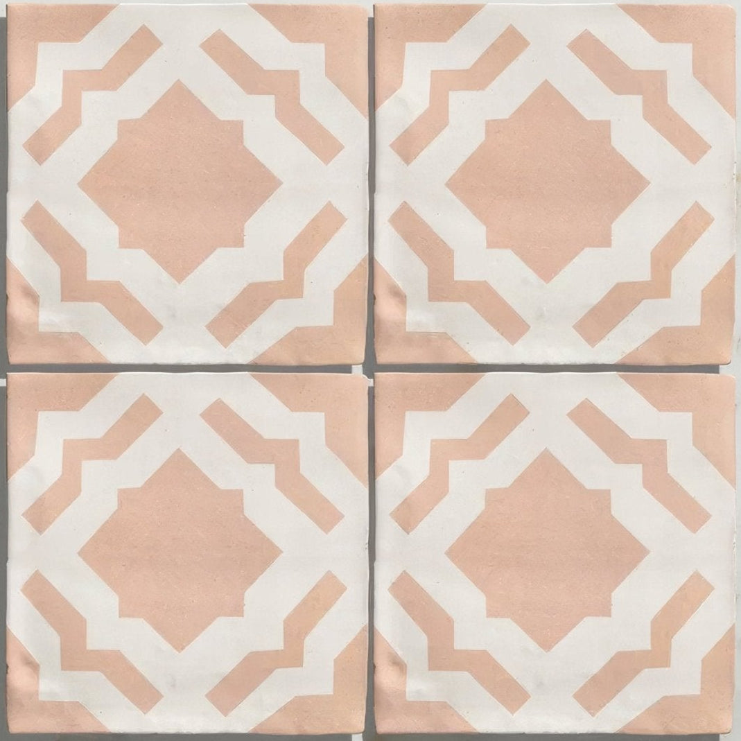 Four square ceramic tiles from studio cassius pink ceramic featuring a soft peach and white geometric pattern