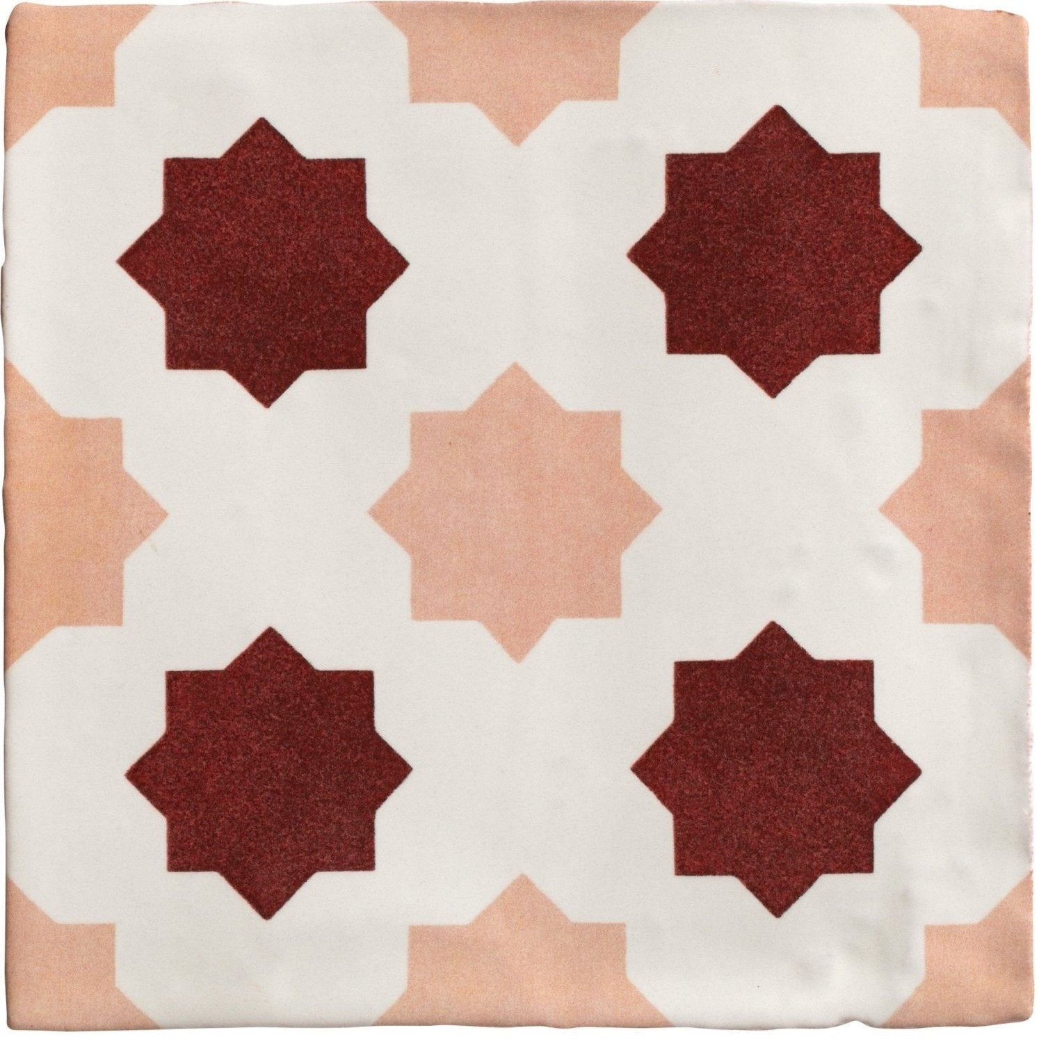 Studio Cosmos Zagora ceramic tile with maroon and blush pink geometric star pattern on white background