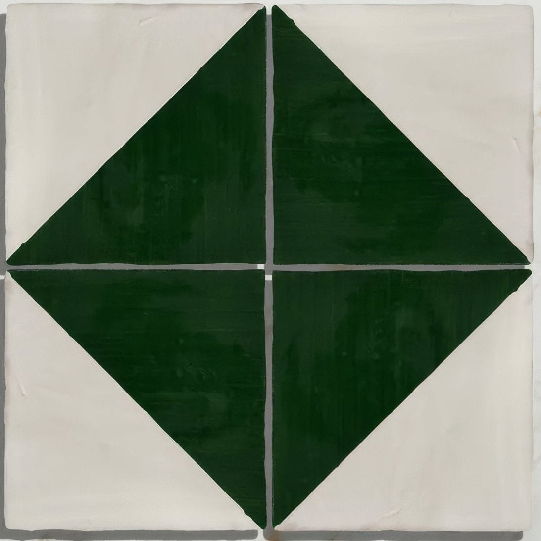 Studio Jamboree handpainted ceramic tile with bold dark green diamond pattern on off-white background