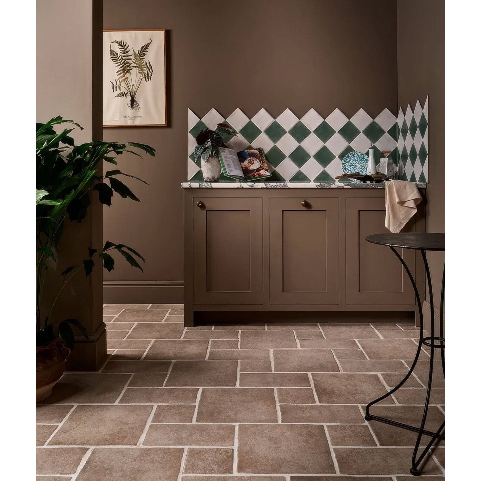 Studio jamboree handpainted ceramic thyme field brown tiled floor with white grout lines in a kitchen setting
