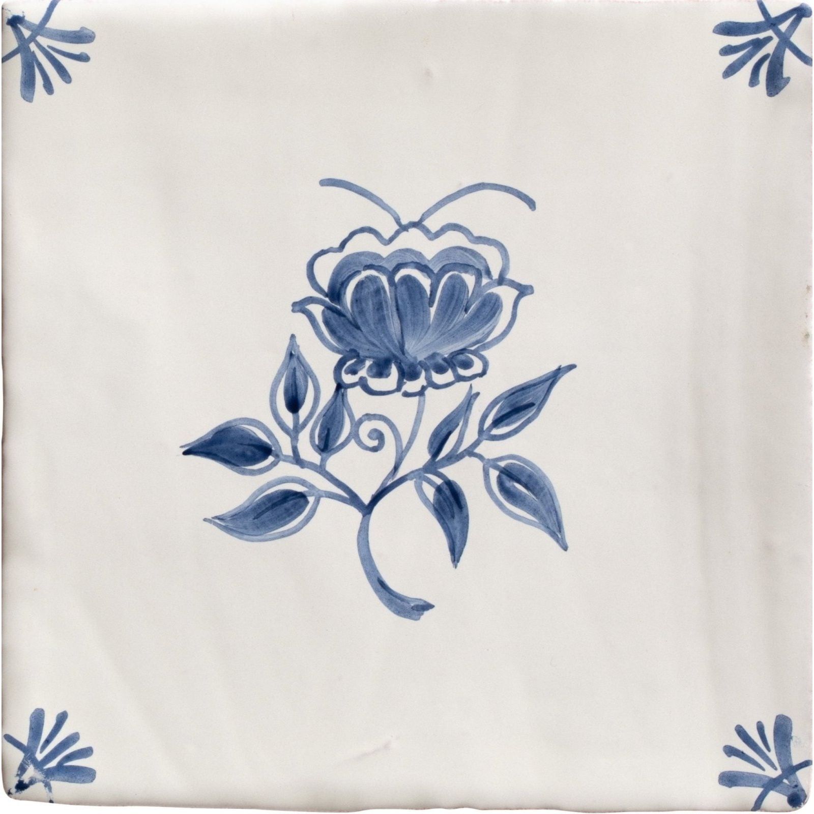 Cream-colored ceramic tile from studio nonnas kitchen classica with delicate blue floral design and corner motifs