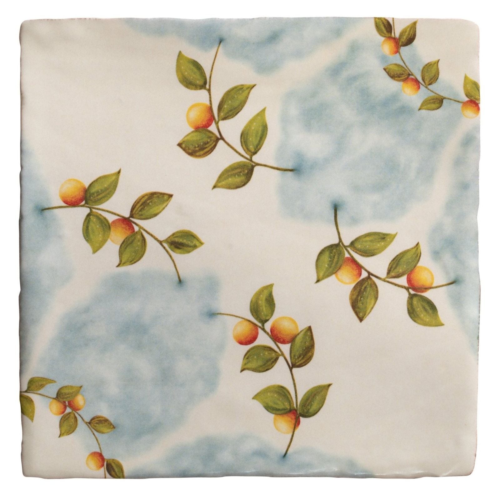 A ceramic tile from Studio Nonna’s Kitchen Nuvola Arancio with blue white marbled background and orange fruit branches