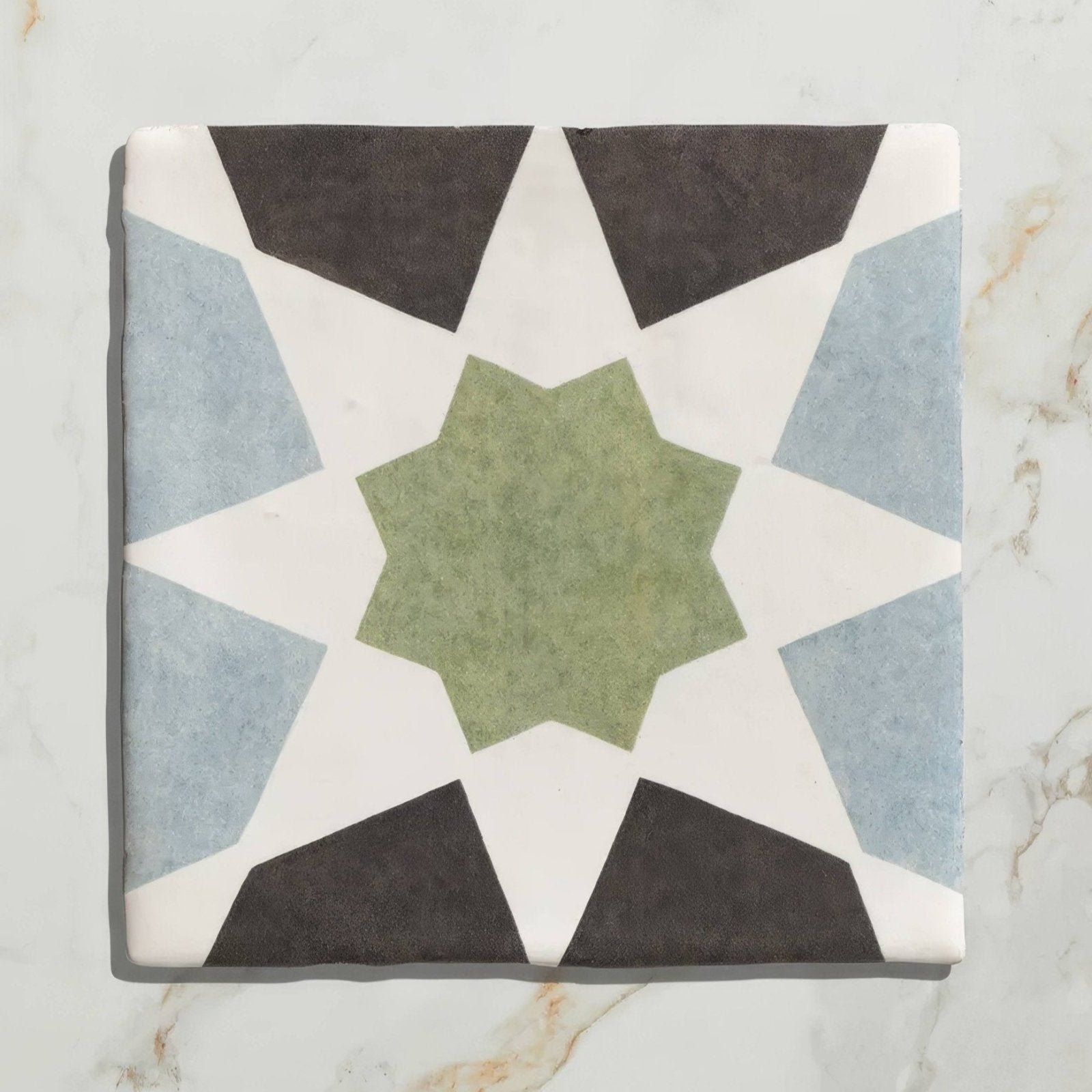 Studio souk green star ceramic square tile with geometric star pattern in muted green light blue and dark gray on white background