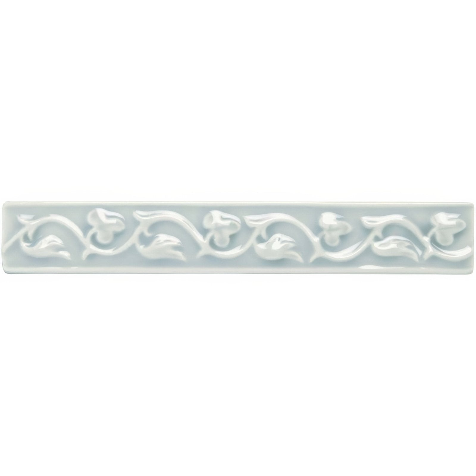 A rectangular light gray ceramic tile with an embossed floral vine pattern from sudbury beaulieu