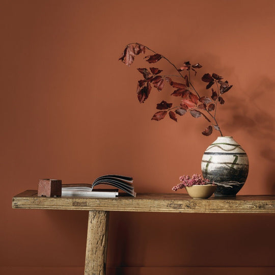 A ceramic vase named taos house with a rounded body and bold black and white abstract brushstroke patterns